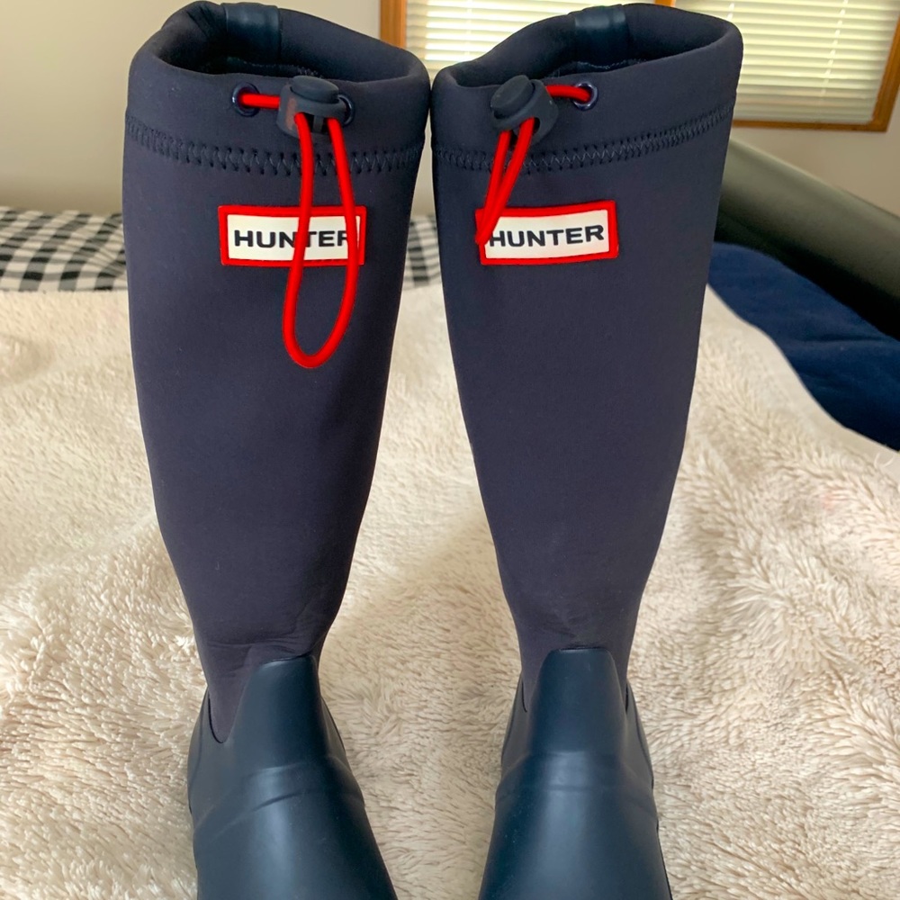 Navy blue Hunter Brand boots.